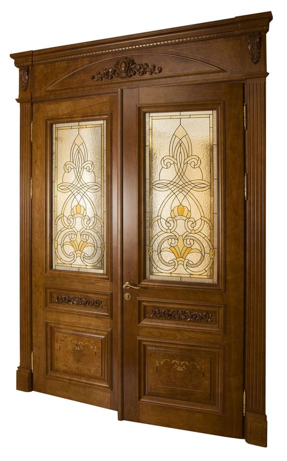 An intricately carved wooden door with ornate Victorian-era patterns, showcasing rich wood grain and timeless elegance.